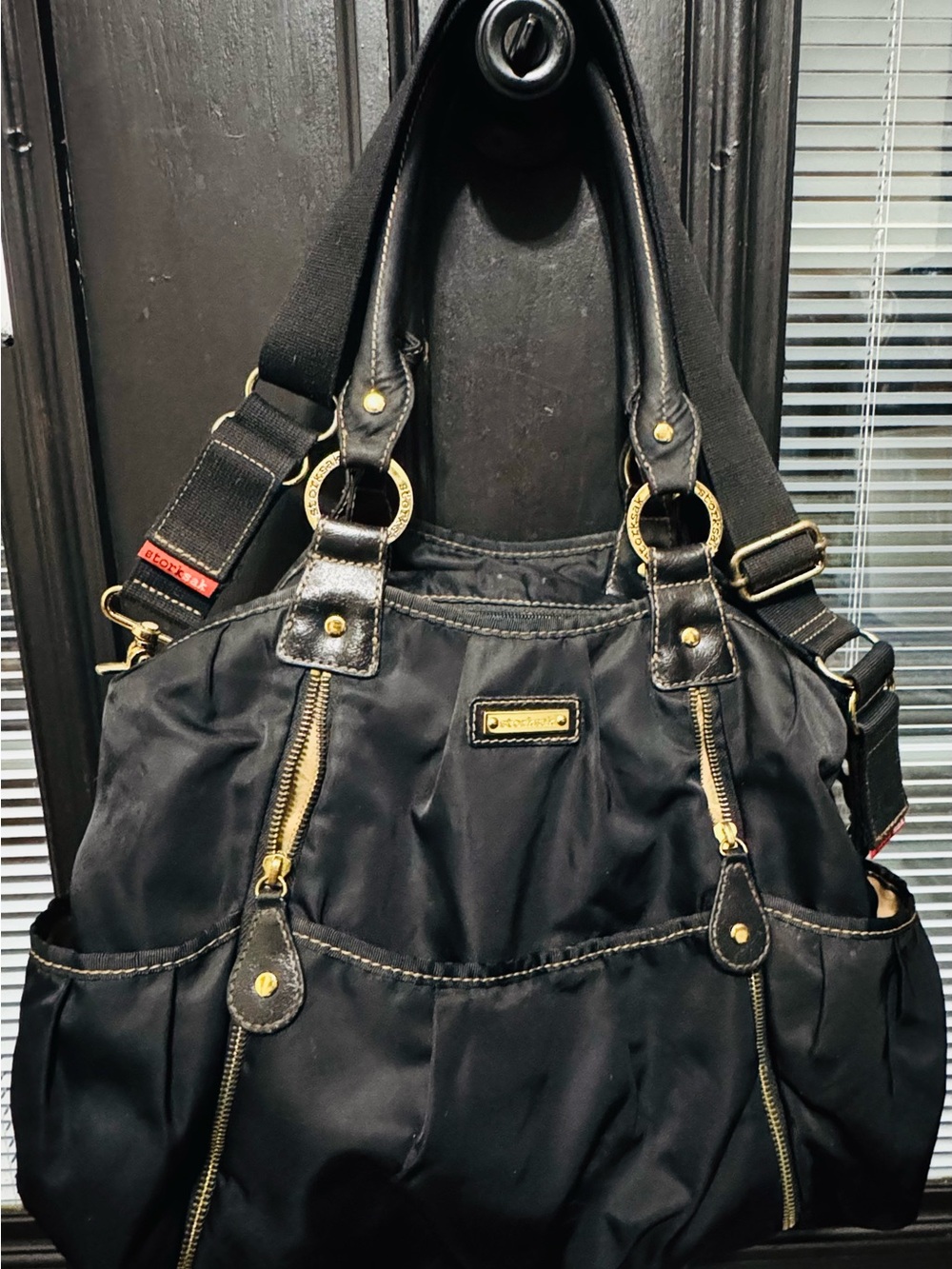 Storksak Black Nylon Messenger Bag with Gold Hardware